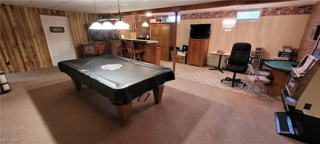 recreation room with a paneled ceiling, pool table, a dry bar, light carpet, and wood walls