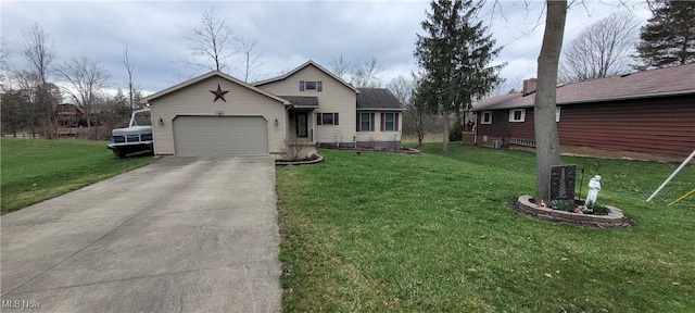 view of front of home with concrete driveway, a front yard, and an attached garage