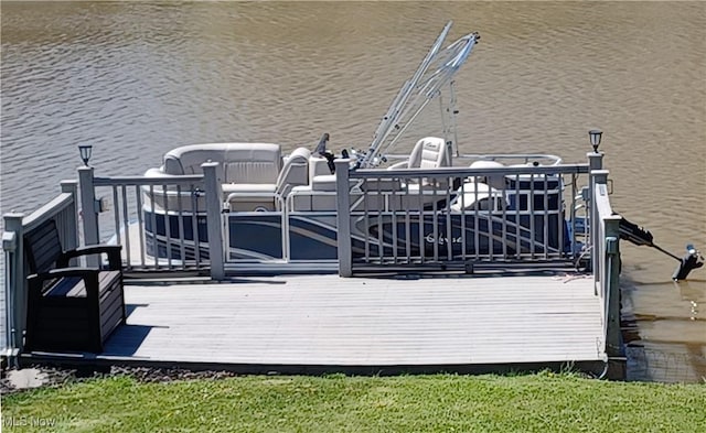 wooden deck with a boat dock and a water view