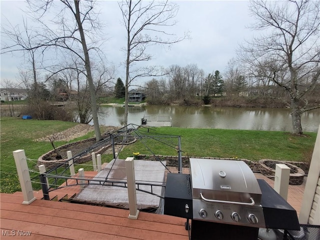 view of dock with a water view and a lawn