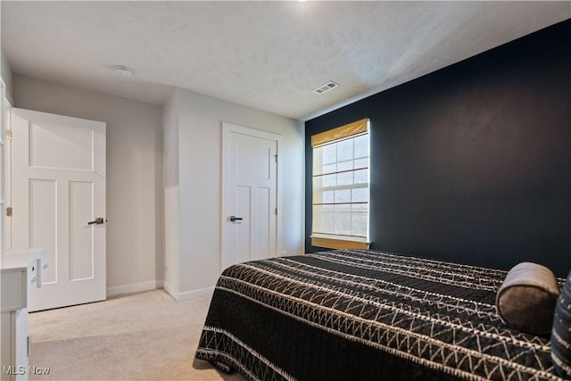 5454 Schueller Blvd, Sheffield Village, OH 44054 - bedroom featuring visible vents, baseboards, light colored carpet, and a textured ceiling
