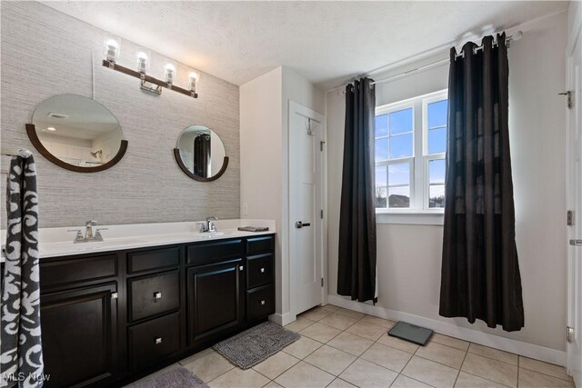 5454 Schueller Blvd, Sheffield Village, OH 44054 - bathroom featuring double vanity, a sink, tile patterned flooring, and baseboards