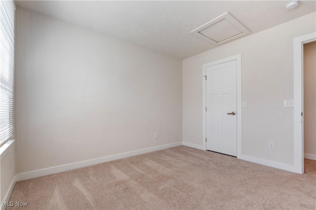 5454 Schueller Blvd, Sheffield Village, OH 44054 - spare room featuring baseboards, carpet flooring, and attic access