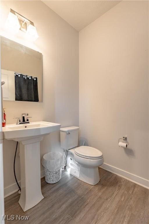 5454 Schueller Blvd, Sheffield Village, OH 44054 - bathroom with toilet, wood finished floors, and baseboards