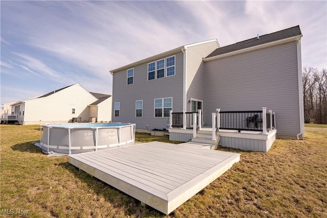 5454 Schueller Blvd, Sheffield Village, OH 44054 - rear view of house featuring an outdoor pool, a deck, and a lawn
