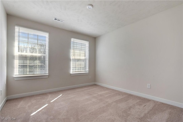 5454 Schueller Blvd, Sheffield Village, OH 44054 - carpeted empty room with a textured ceiling, baseboards, and visible vents