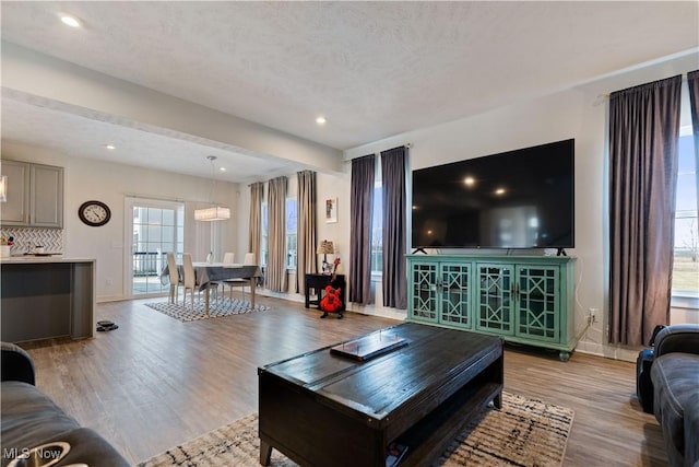 5454 Schueller Blvd, Sheffield Village, OH 44054 - living area with baseboards, light wood-type flooring, a notable chandelier, and recessed lighting
