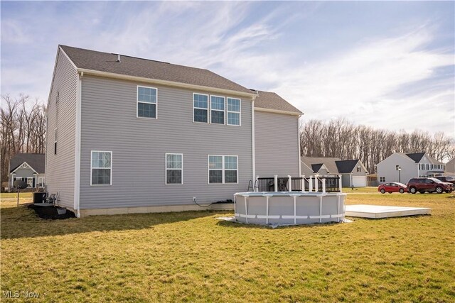 5454 Schueller Blvd, Sheffield Village, OH 44054 - rear view of house featuring an outdoor pool, central AC, and a lawn