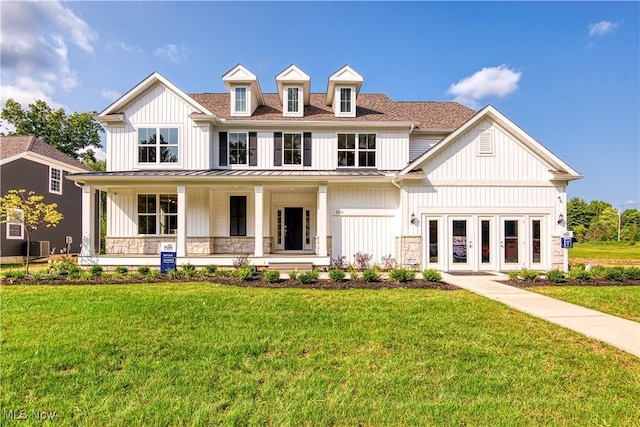 3691 Summerfield Ln, Richfield, OH 44286 - modern inspired farmhouse with a standing seam roof, a front yard, a porch, and board and batten siding