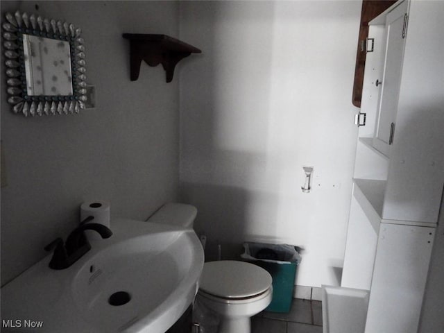 39 E Main St, Crooksville, OH 43731 - half bathroom with a sink, tile patterned floors, and toilet
