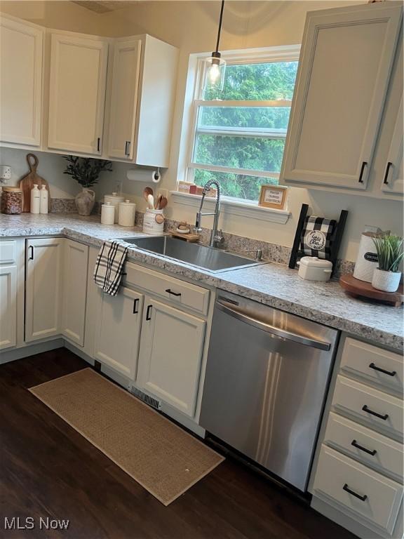 kitchen featuring dishwasher, a sink, white cabinets, and dark wood-style flooring
