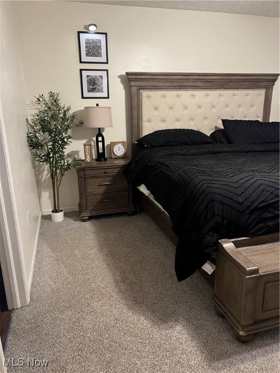 carpeted bedroom with baseboards