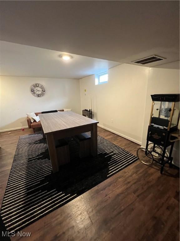 dining area with visible vents, baseboards, and dark wood finished floors