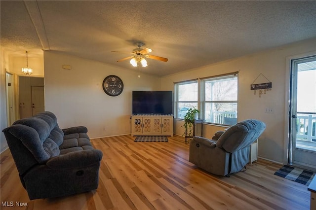 8672 Ridgeview Rd, Chandlersville, OH 43727 - living area with baseboards, light wood-type flooring, a ceiling fan, and a textured ceiling