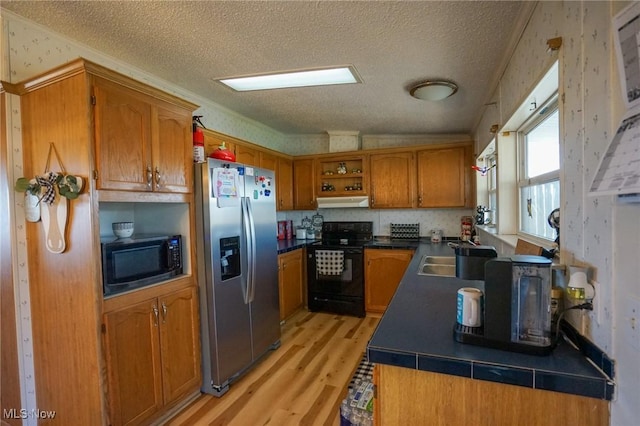 8672 Ridgeview Rd, Chandlersville, OH 43727 - kitchen with a textured ceiling, brown cabinets, open shelves, black appliances, and light wood-type flooring