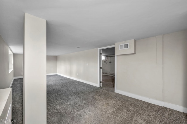empty room featuring visible vents, baseboards, and carpet flooring