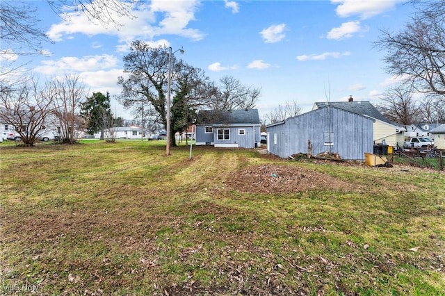 view of yard featuring fence and an outdoor structure