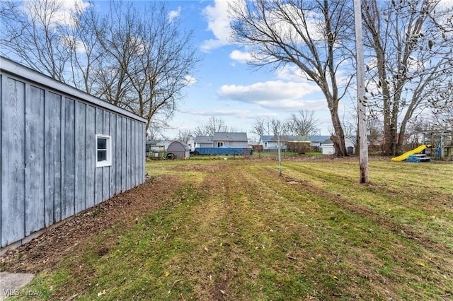 view of yard with an outbuilding and a playground