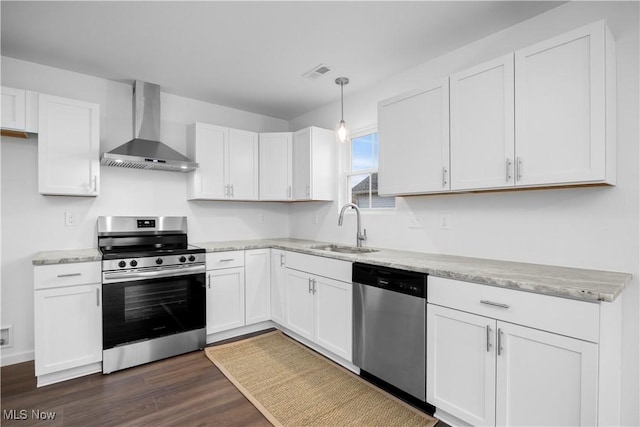 1996 E Oldgate Rd, Sandusky, OH 44870 - kitchen featuring white cabinets, visible vents, wall chimney exhaust hood, appliances with stainless steel finishes, and a sink