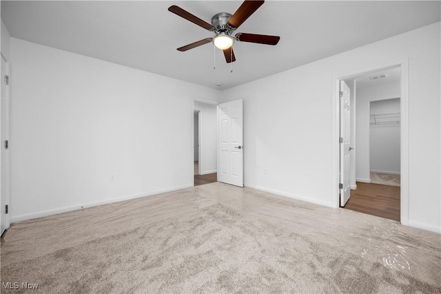 1996 E Oldgate Rd, Sandusky, OH 44870 - unfurnished bedroom with a ceiling fan, a spacious closet, visible vents, carpet floors, and baseboards