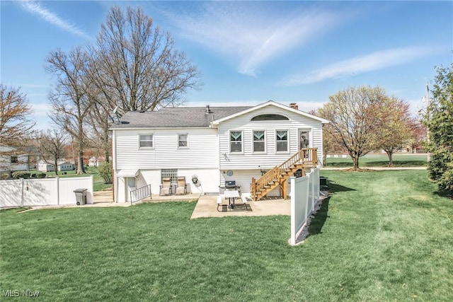 back of property featuring a patio, stairway, fence, and a lawn