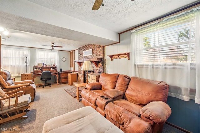 living room featuring carpet flooring, a textured ceiling, and ceiling fan
