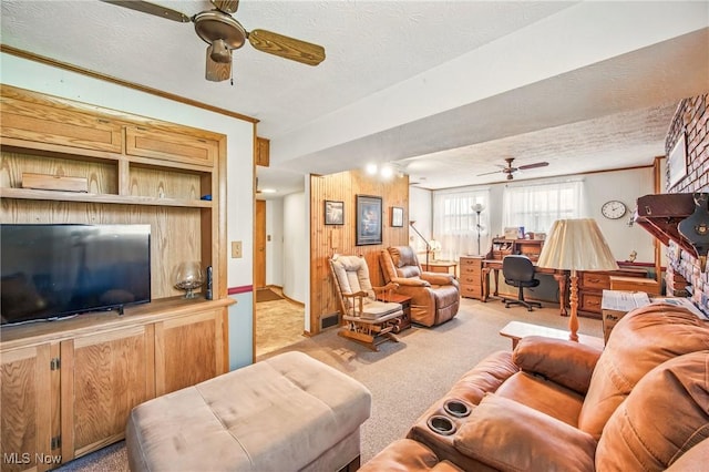 carpeted living room featuring visible vents, a textured ceiling, and a ceiling fan