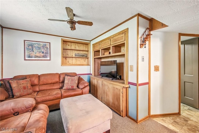 living area featuring built in features, baseboards, ornamental molding, ceiling fan, and a textured ceiling