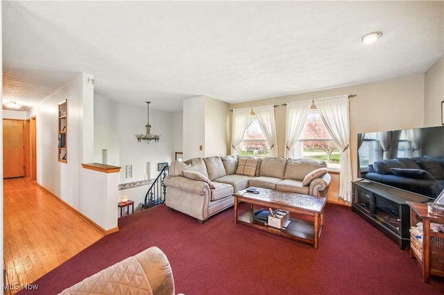 carpeted living room with a chandelier