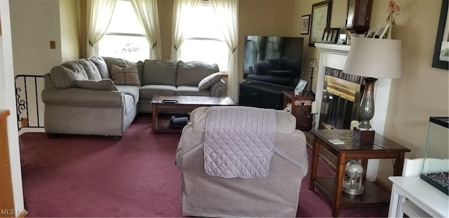carpeted living area with a glass covered fireplace