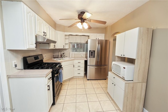 kitchen featuring a sink, decorative backsplash, under cabinet range hood, and stainless steel appliances