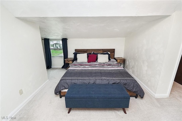 bedroom featuring baseboards and carpet floors