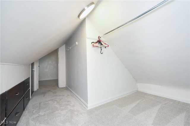bonus room featuring light colored carpet, baseboards, and lofted ceiling