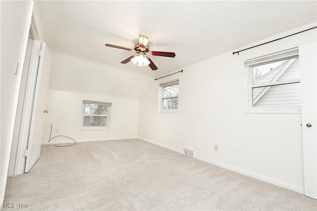 unfurnished bedroom with visible vents, baseboards, carpet, and lofted ceiling