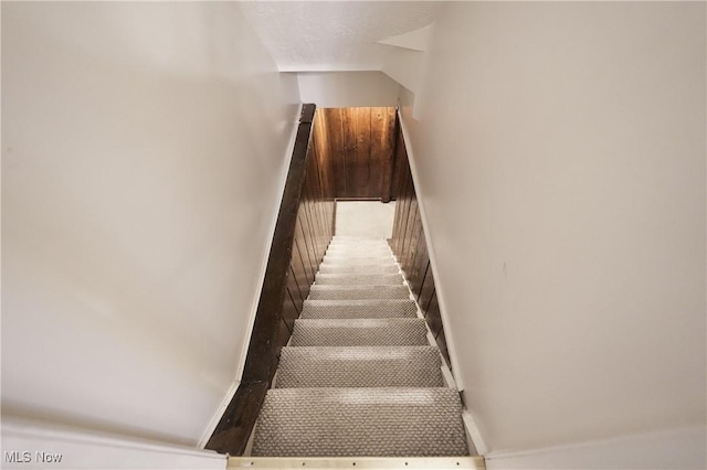 stairway featuring baseboards