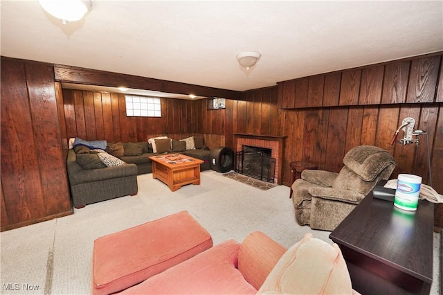 carpeted living area featuring wooden walls and a fireplace