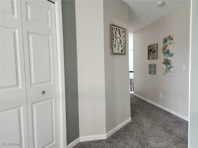 hallway featuring baseboards and carpet floors