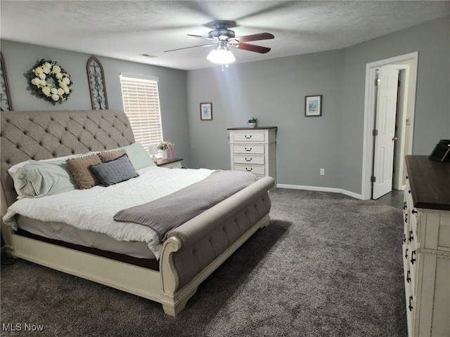 bedroom with visible vents, baseboards, dark colored carpet, and a textured ceiling