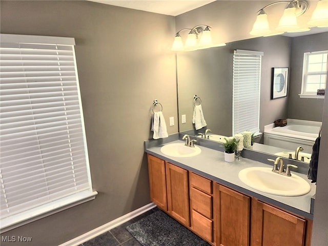 full bathroom with a sink, tile patterned floors, double vanity, and a bath