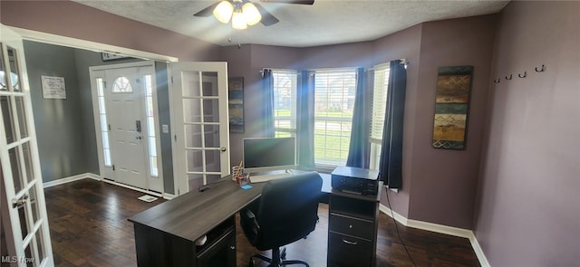 office area with a ceiling fan, a textured ceiling, baseboards, and dark wood finished floors