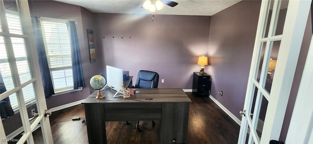 office space with baseboards, a ceiling fan, and dark wood-style floors