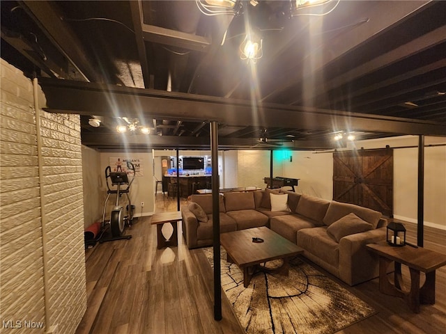 finished below grade area featuring baseboards and wood finished floors