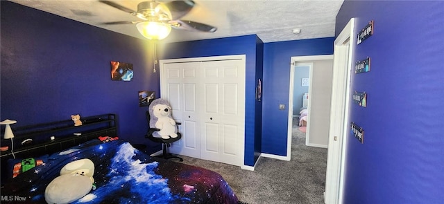 carpeted bedroom with baseboards, a ceiling fan, and a textured ceiling