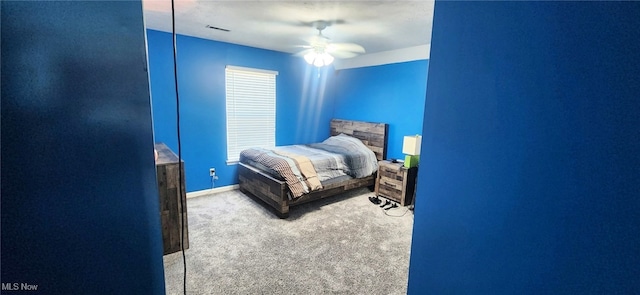 bedroom featuring carpet floors, baseboards, a ceiling fan, and visible vents