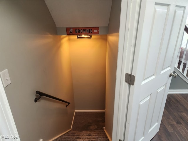 stairway with baseboards and wood finished floors