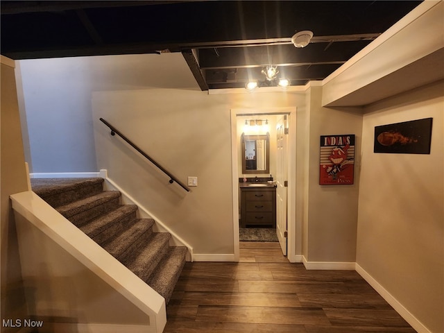 stairs with wood finished floors and baseboards