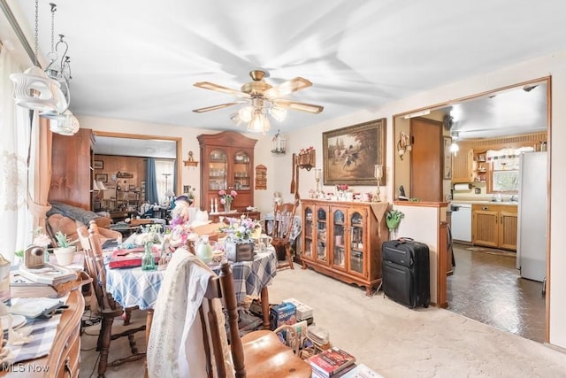 living room featuring light colored carpet and a ceiling fan