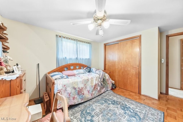 bedroom with a closet, baseboards, and a ceiling fan