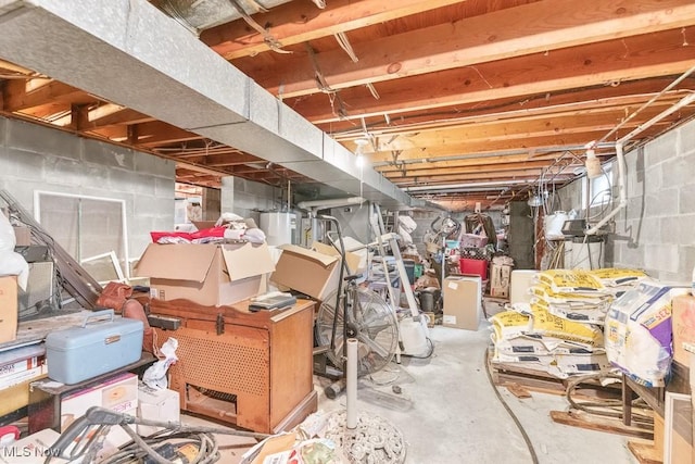 unfinished basement featuring water heater