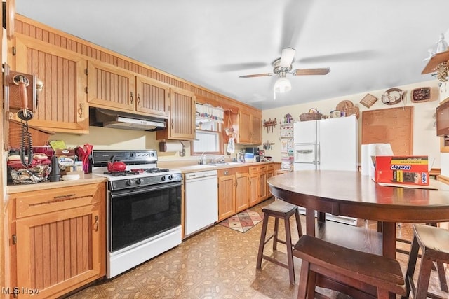 kitchen featuring ceiling fan, white appliances, light floors, under cabinet range hood, and light countertops
